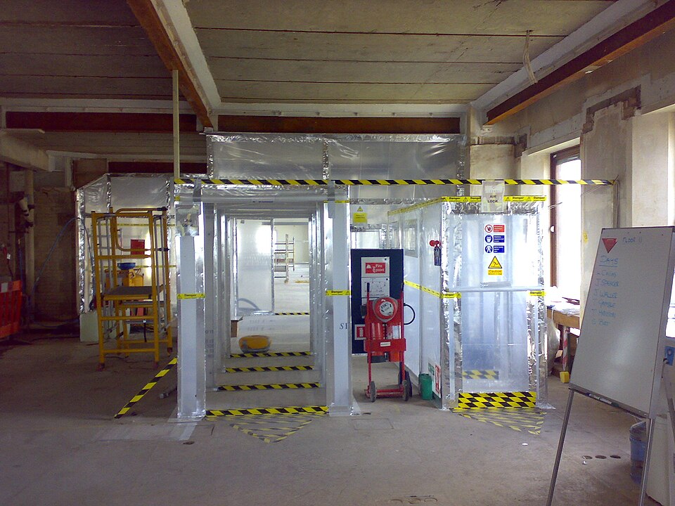 Sealed asbestos removal enclosure with airlock and hazard tape